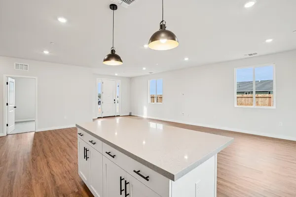a room with wooden floor and chandelier