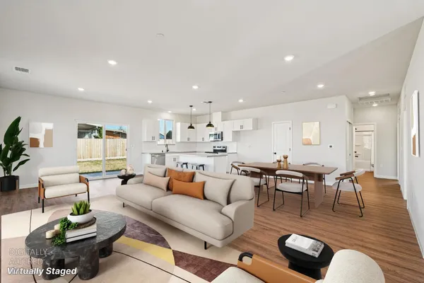 a living room with furniture and wooden floor
