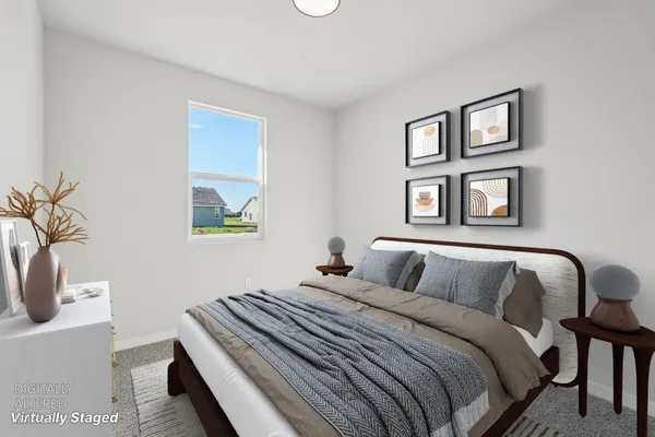 a bedroom with a bed and a painting on the wall