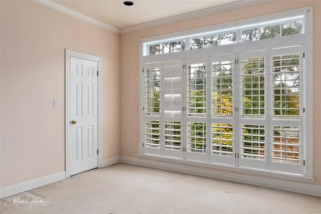 a view of an empty room with a closet and racks