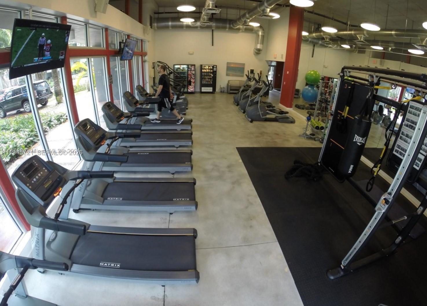 650 Northeast 64th Street, Unit G407 Miami, FL 33138 - Photo 2 of 5 a view of a room with gym equipment