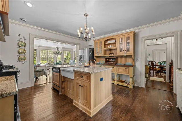 a kitchen with stainless steel appliances granite countertop lots of counter top space and wooden floor