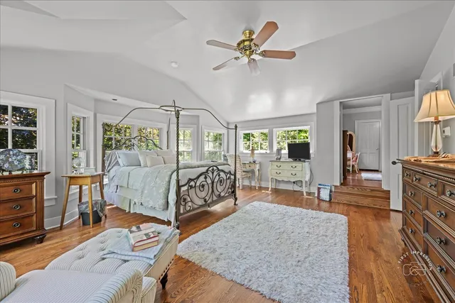 a bed room with a bed a couch and dresser