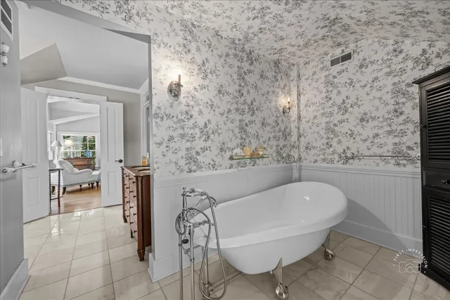 a bath tub sitting in a bathroom and mirror