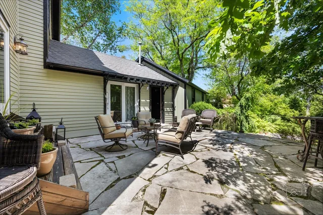 a view of backyard with outdoor seating and plants