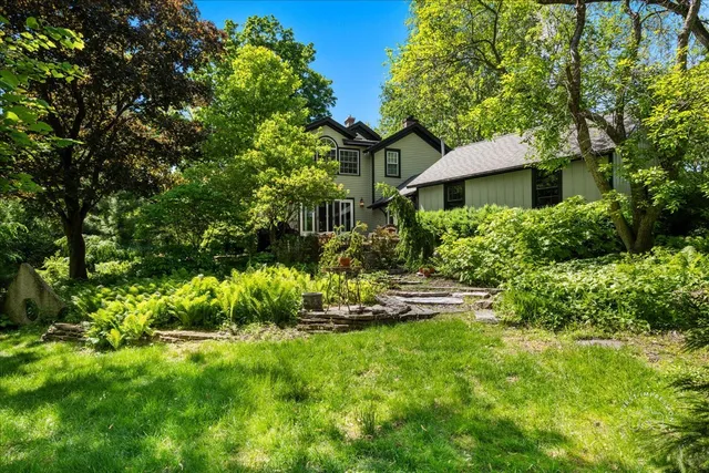 a view of a house with a yard and sitting area
