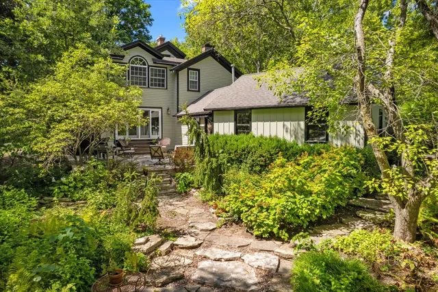 a front view of a house with a yard and fountain