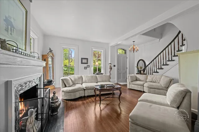 a living room with fireplace furniture and a wooden floor