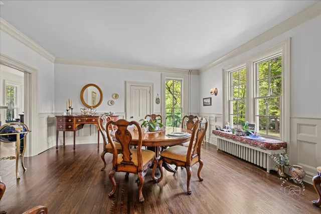 a dining room with furniture window and wooden floor