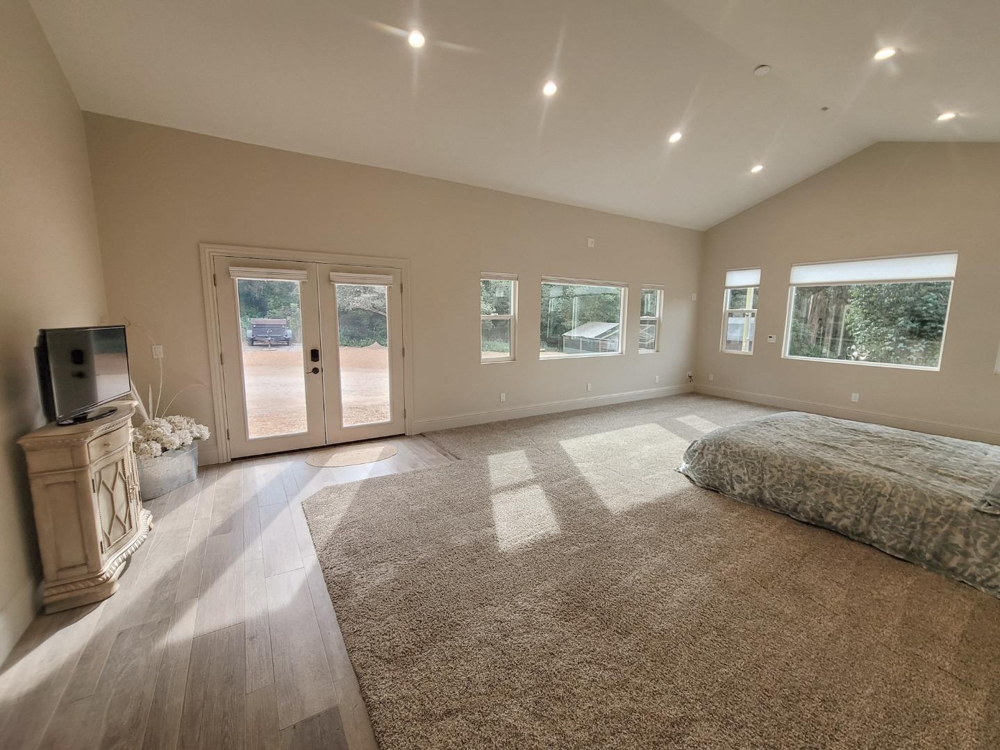 17329 McGuffie Road Salinas, CA 93907 - Photo 11 of 27 a spacious bedroom with a large bed and a couch