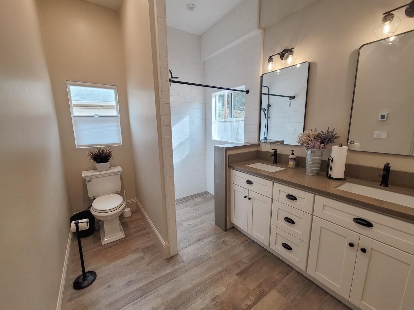 17329 McGuffie Road Salinas, CA 93907 - Photo 12 of 27 a bathroom with a toilet sink and mirror
