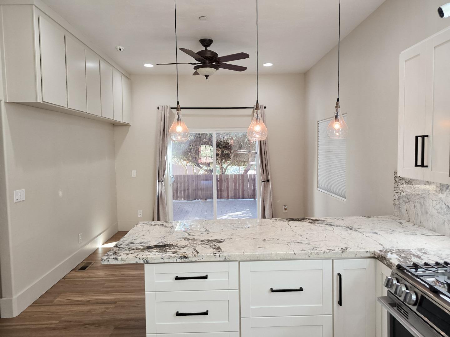 17329 McGuffie Road Salinas, CA 93907 - Photo 5 of 27 a kitchen with granite countertop a sink appliances and cabinets