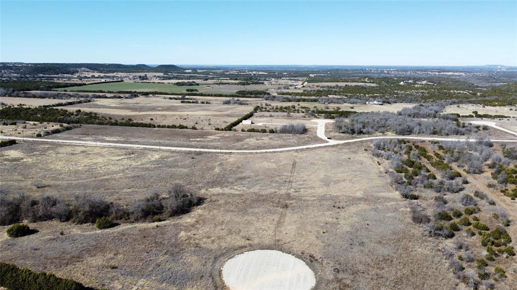 1295 Valley Ranch Road Glen Rose, TX 76043 - Photo 3 of 7 a view of a dry yard with large trees