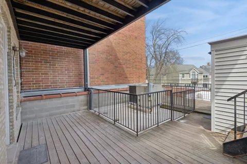 a view of a balcony with wooden floor