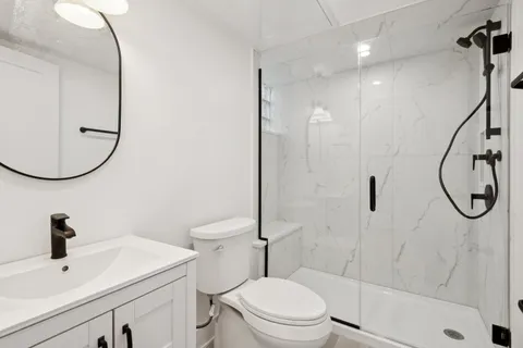 a bathroom with a sink toilet and shower
