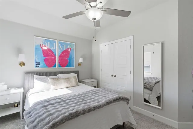 a bedroom with a bed and a painting on the wall