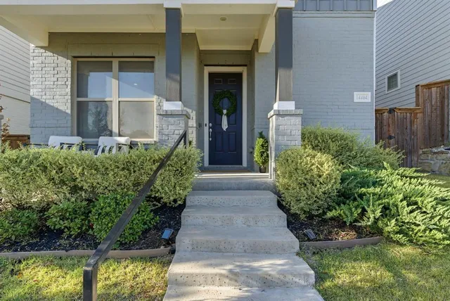 an entrance to house with yard and green space