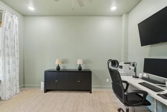 a room with a chair and flat screen tv