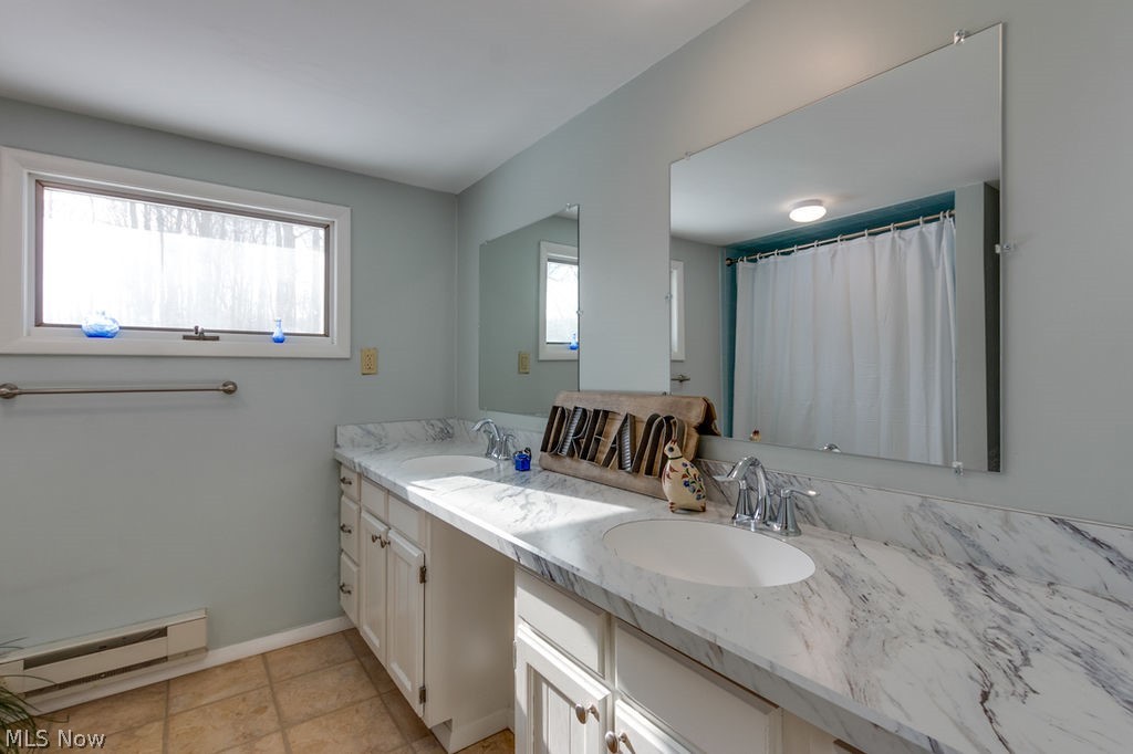 12529 Pearl Road Chardon, OH 44024 - Photo 21 of 33 Another one of the full baths - double vanities with new counters in grey and white has an alabaster look to is, double mirrors, tube with tile surround, lovely vanities with room for a chair or laundry baskets, space space space...this is the second full bath upstaris
