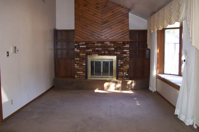 a view of an empty room with a fireplace