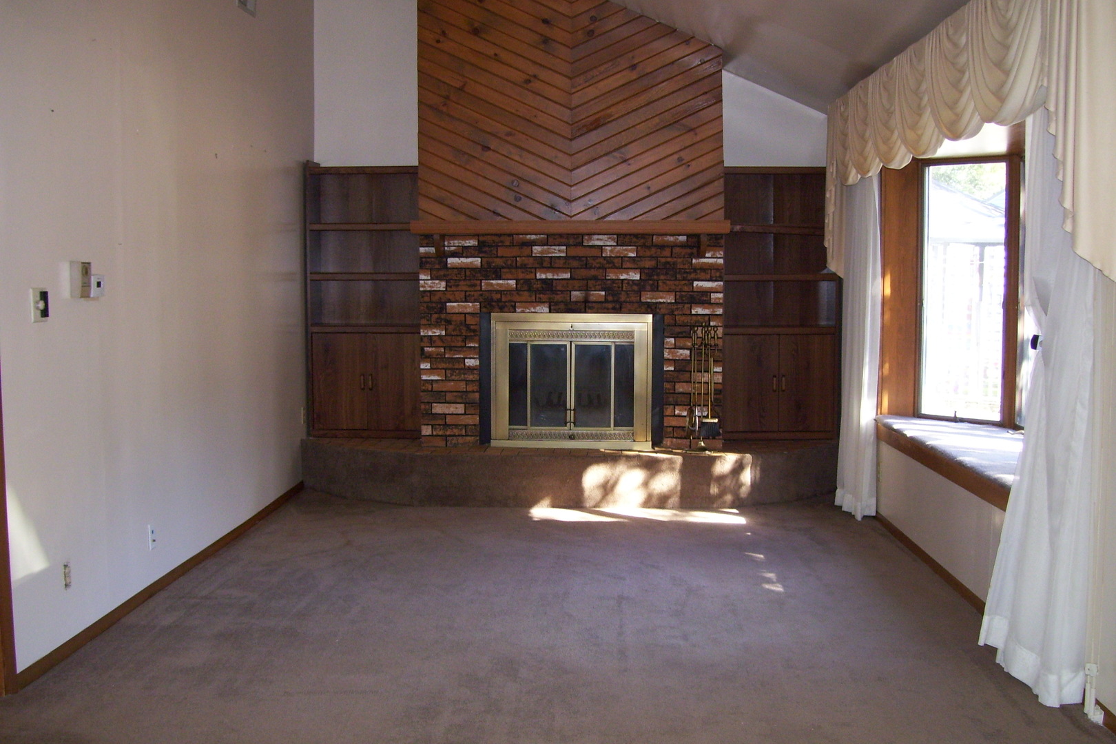1141 Eastview Drive Rantoul, IL 61866 - Photo 3 of 9 a view of an empty room with a fireplace