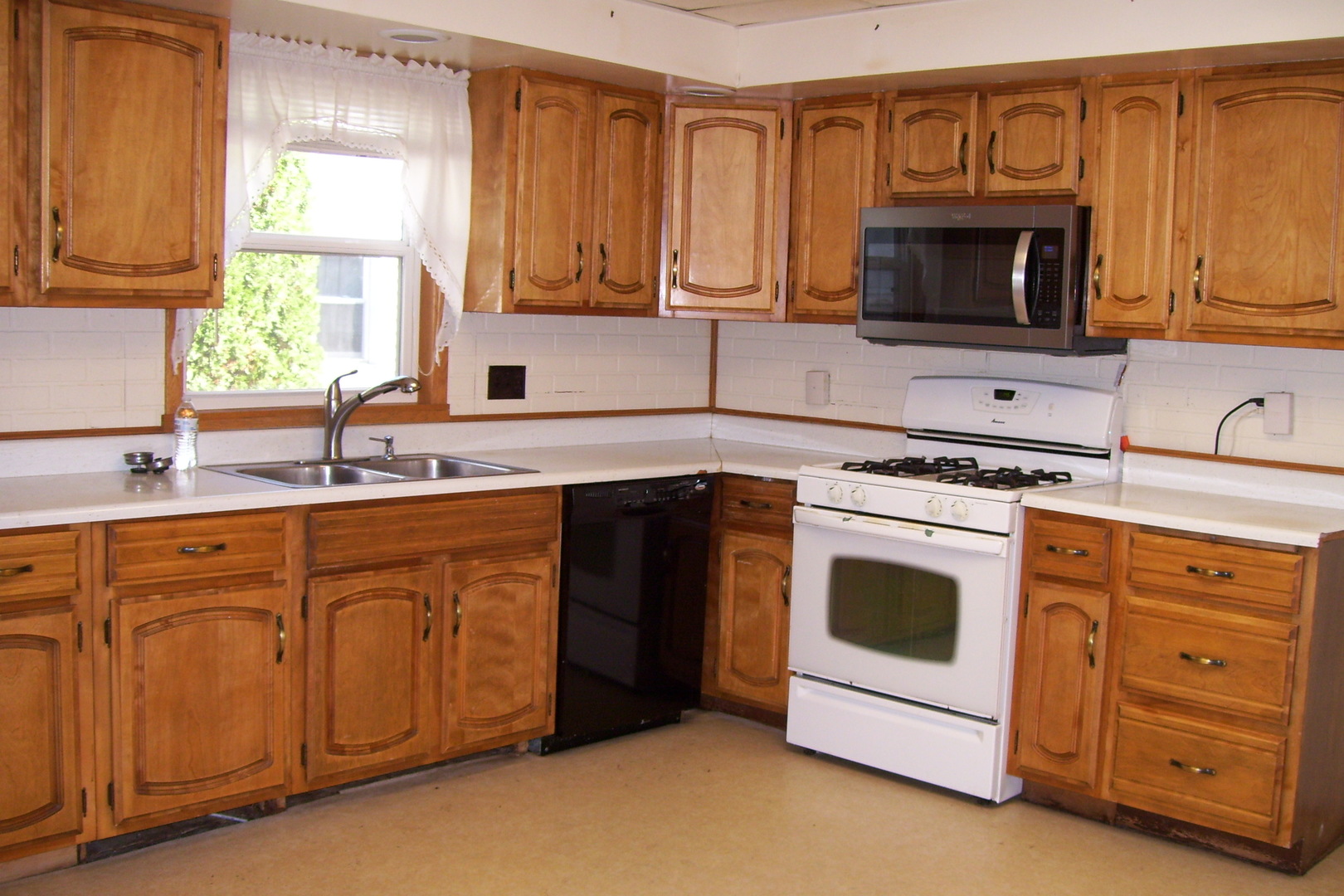 1141 Eastview Drive Rantoul, IL 61866 - Photo 4 of 9 a kitchen with stainless steel appliances granite countertop a sink stove and microwave