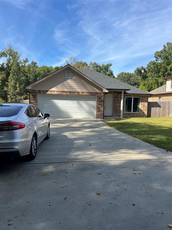 2307 Smith Drive Longview, TX 75605 - Photo 1 of 1 a front view of a house with a garden