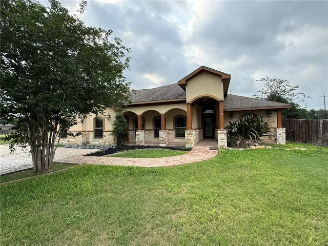 a front view of a house with swimming pool having outdoor seating