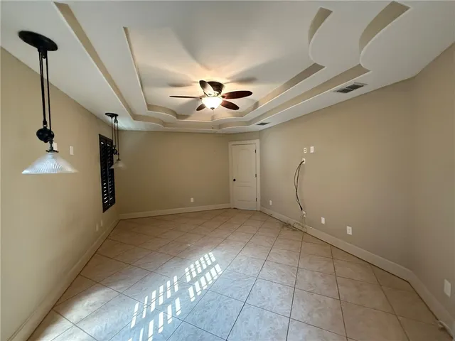 a view of a livingroom with a ceiling fan and window
