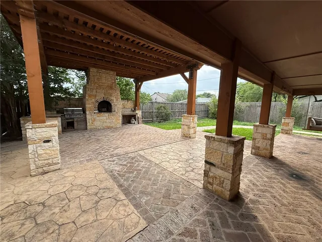 a view of a patio with a dining table and chairs