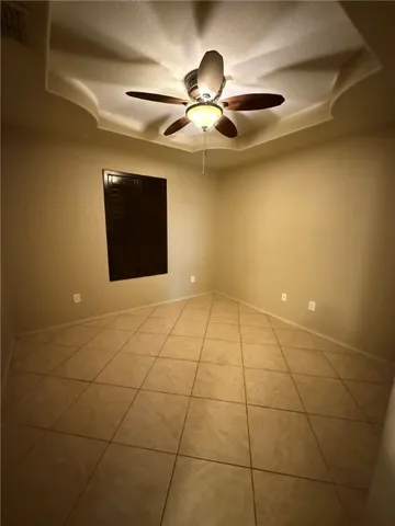 a view of an empty room with a ceiling fan