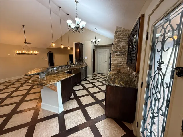 a view of a dining room with furniture and chandelier