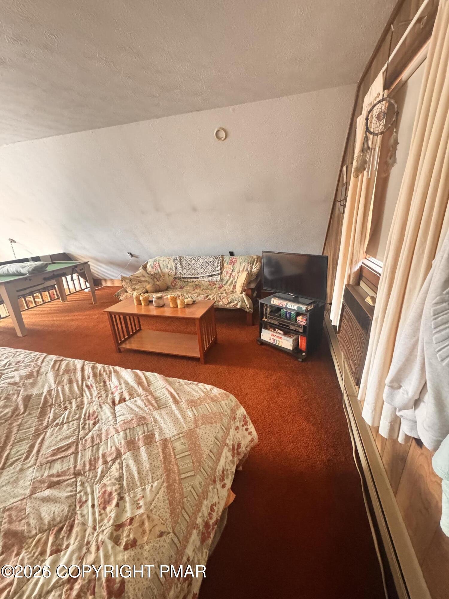 166 Dover Drive Bushkill, PA 18324 - Photo 18 of 21 a bed sitting in a bedroom next to a window