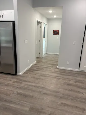 a view of a hallway with wooden floor