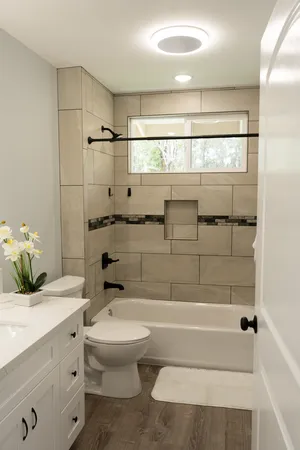 a bathroom with a bathtub shower sink and toilet