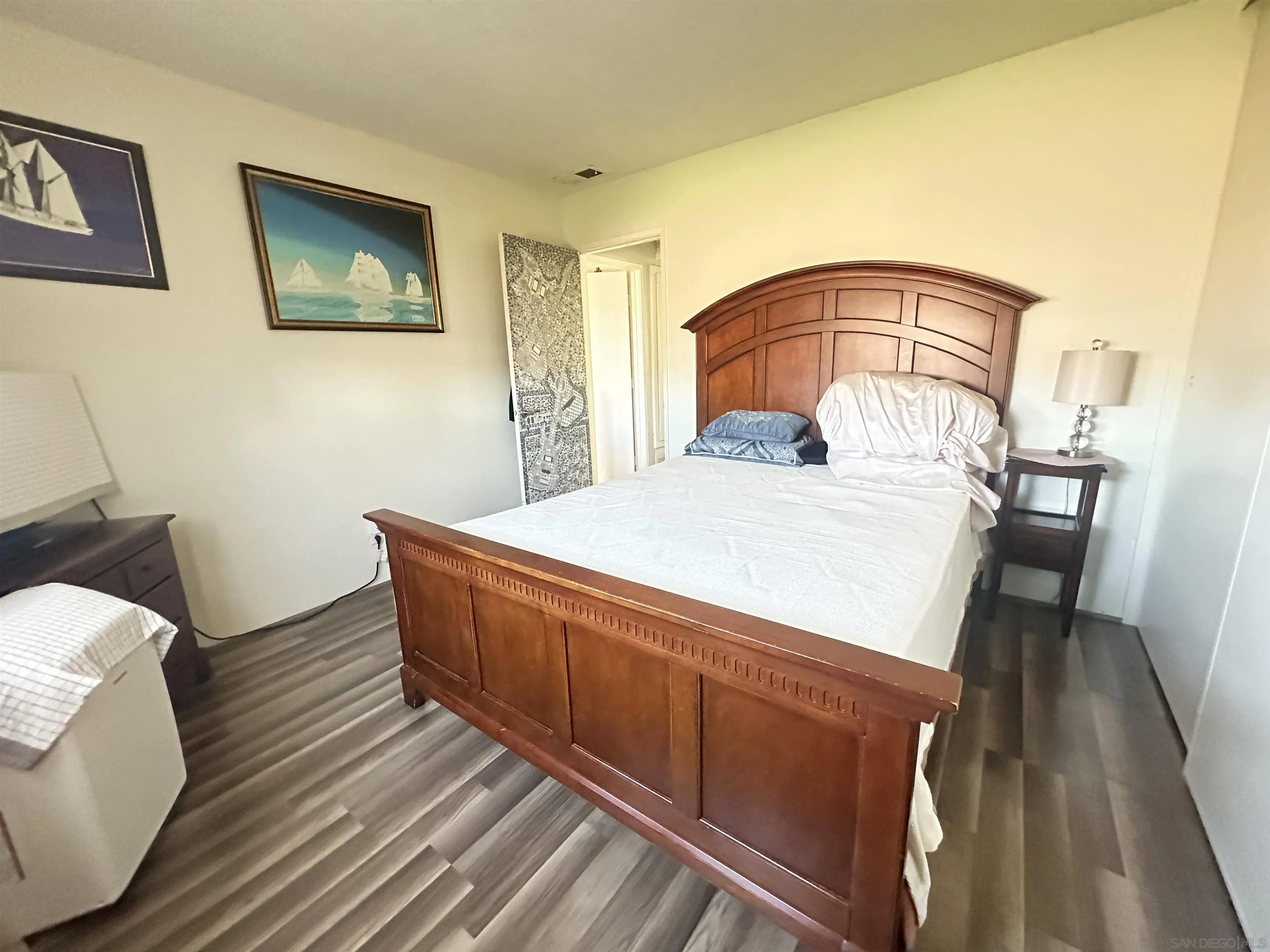 1046 Bartlett Drive Vista, CA 92084 - Photo 4 of 12 a living room with a bed furniture and a wooden floor