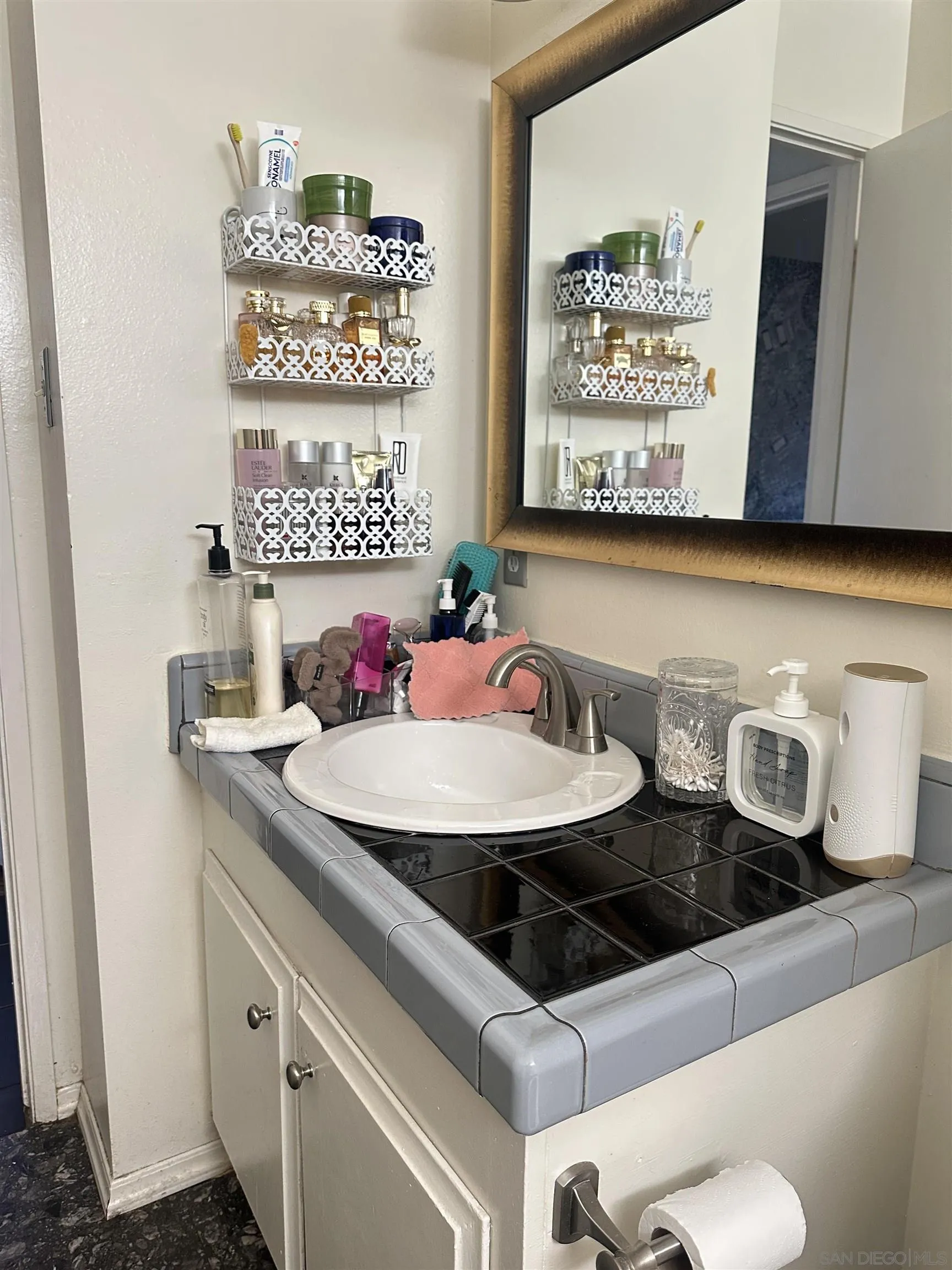 1046 Bartlett Drive Vista, CA 92084 - Photo 5 of 12 a bathroom with a sink and a mirror