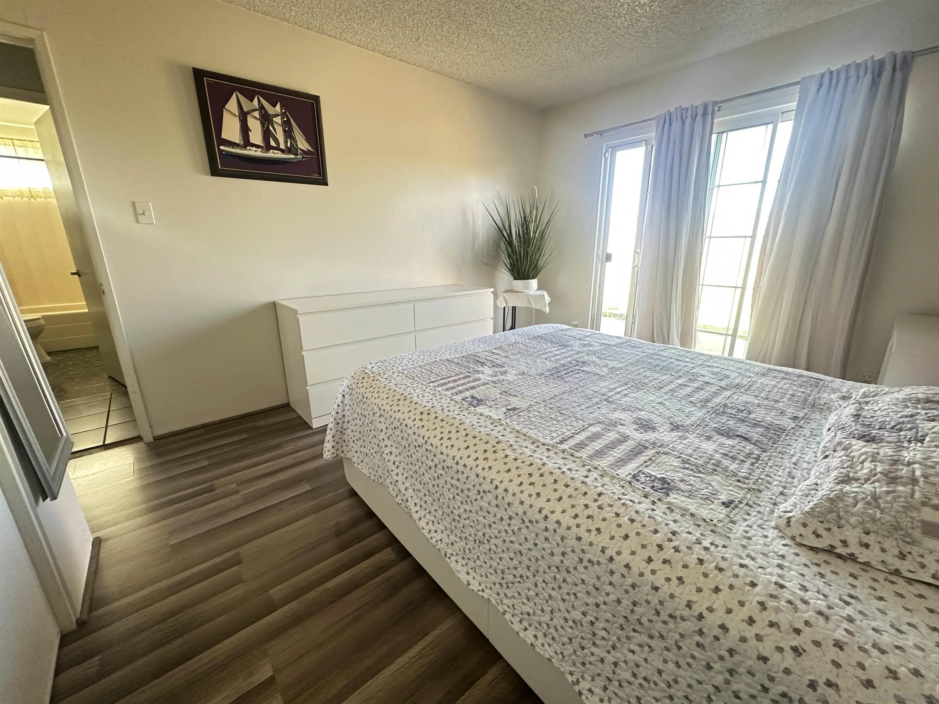 1046 Bartlett Drive Vista, CA 92084 - Photo 7 of 12 a bedroom with a bed and a window