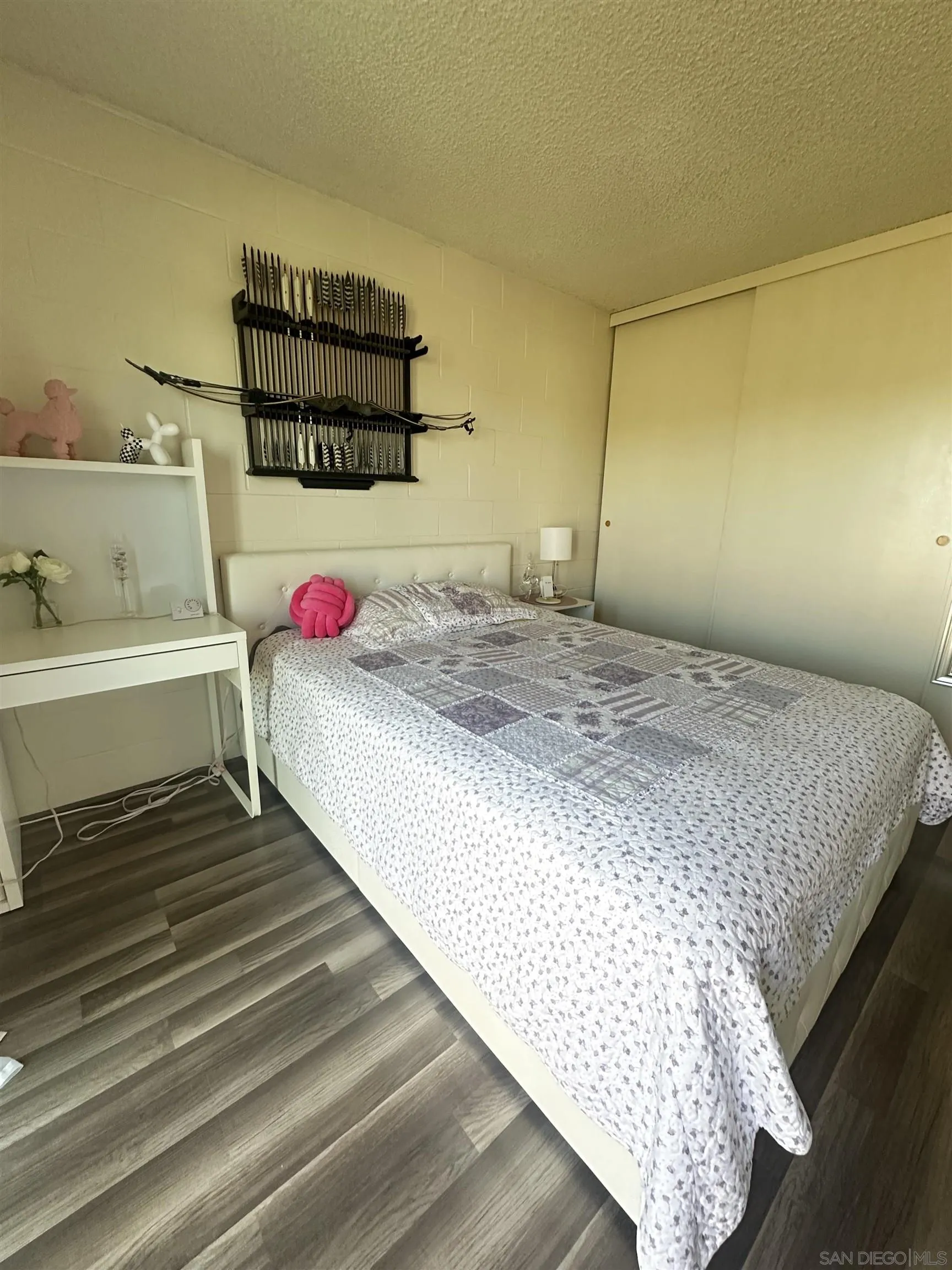 1046 Bartlett Drive Vista, CA 92084 - Photo 8 of 12 a bedroom with a bed and a potted plant on the dresser
