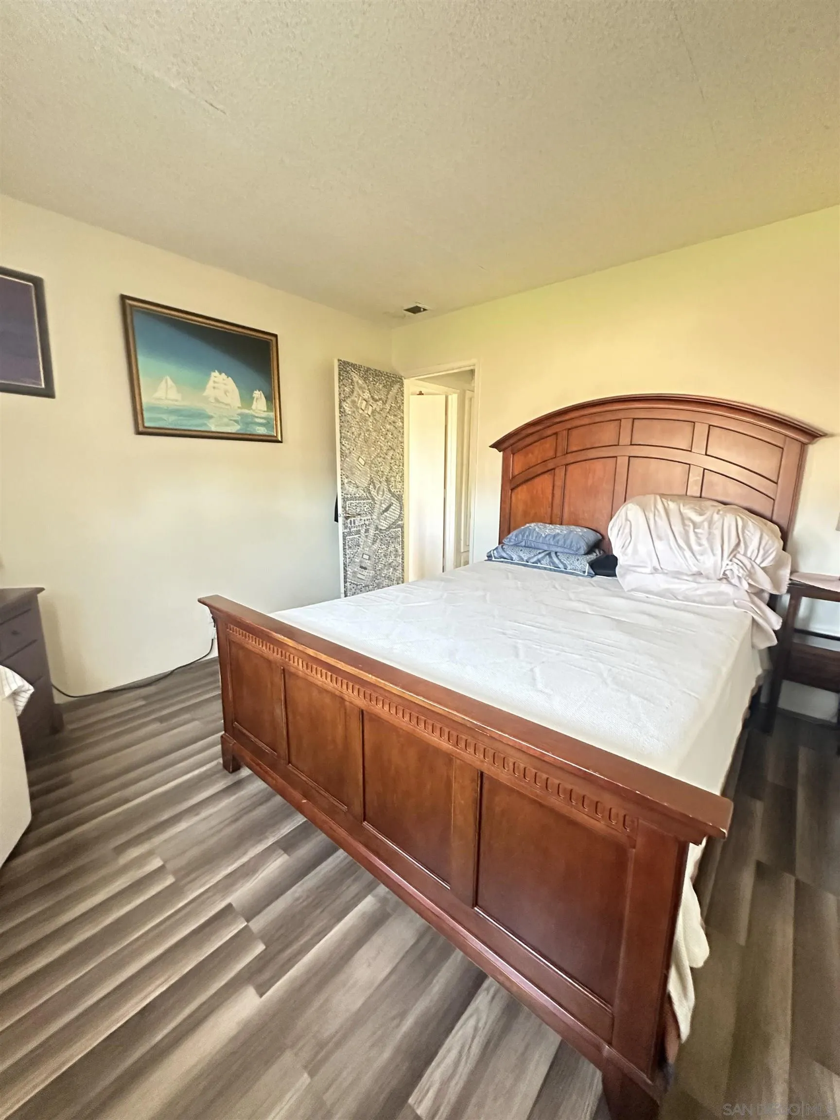 1046 Bartlett Drive Vista, CA 92084 - Photo 9 of 12 a spacious bedroom with a bed and a dresser