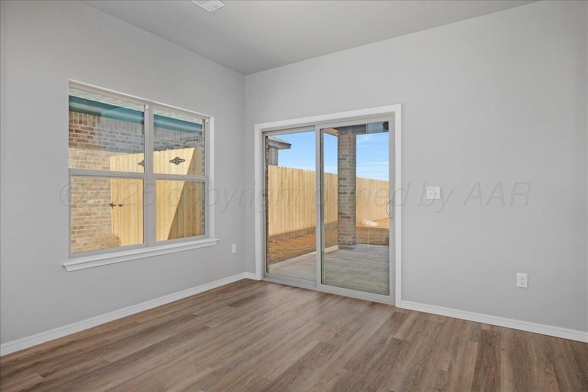 4300 Beacon Road Amarillo, TX 79118 - Photo 11 of 20 an empty room with wooden floor and windows