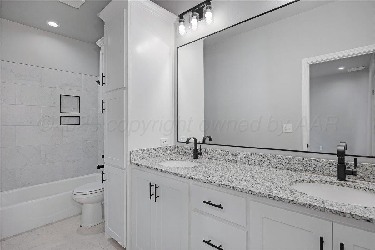 4300 Beacon Road Amarillo, TX 79118 - Photo 14 of 20 a bathroom with a granite countertop sink toilet and shower