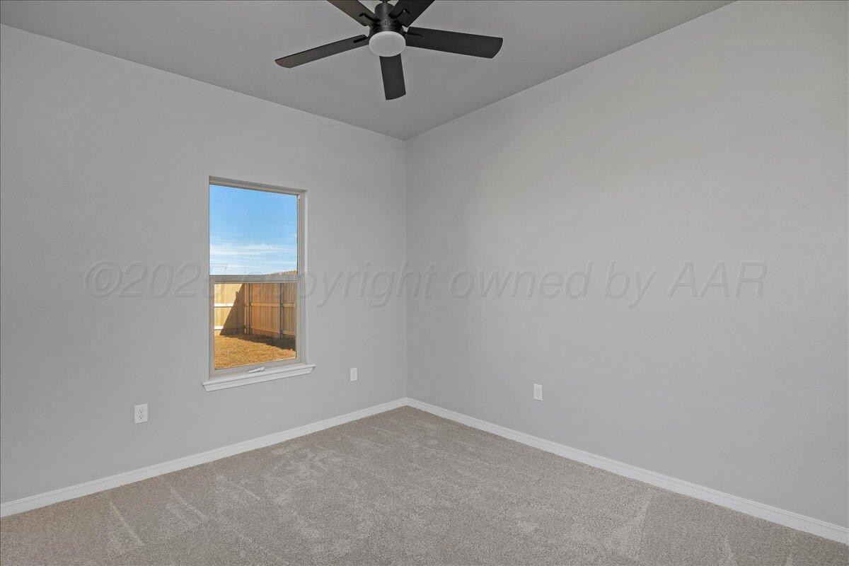 4300 Beacon Road Amarillo, TX 79118 - Photo 16 of 20 an empty room with a window and a fan