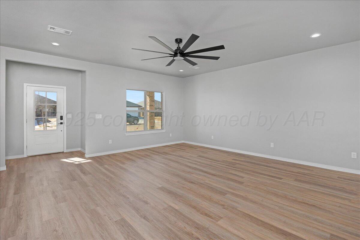 4300 Beacon Road Amarillo, TX 79118 - Photo 4 of 20 wooden floor in an empty room with a window