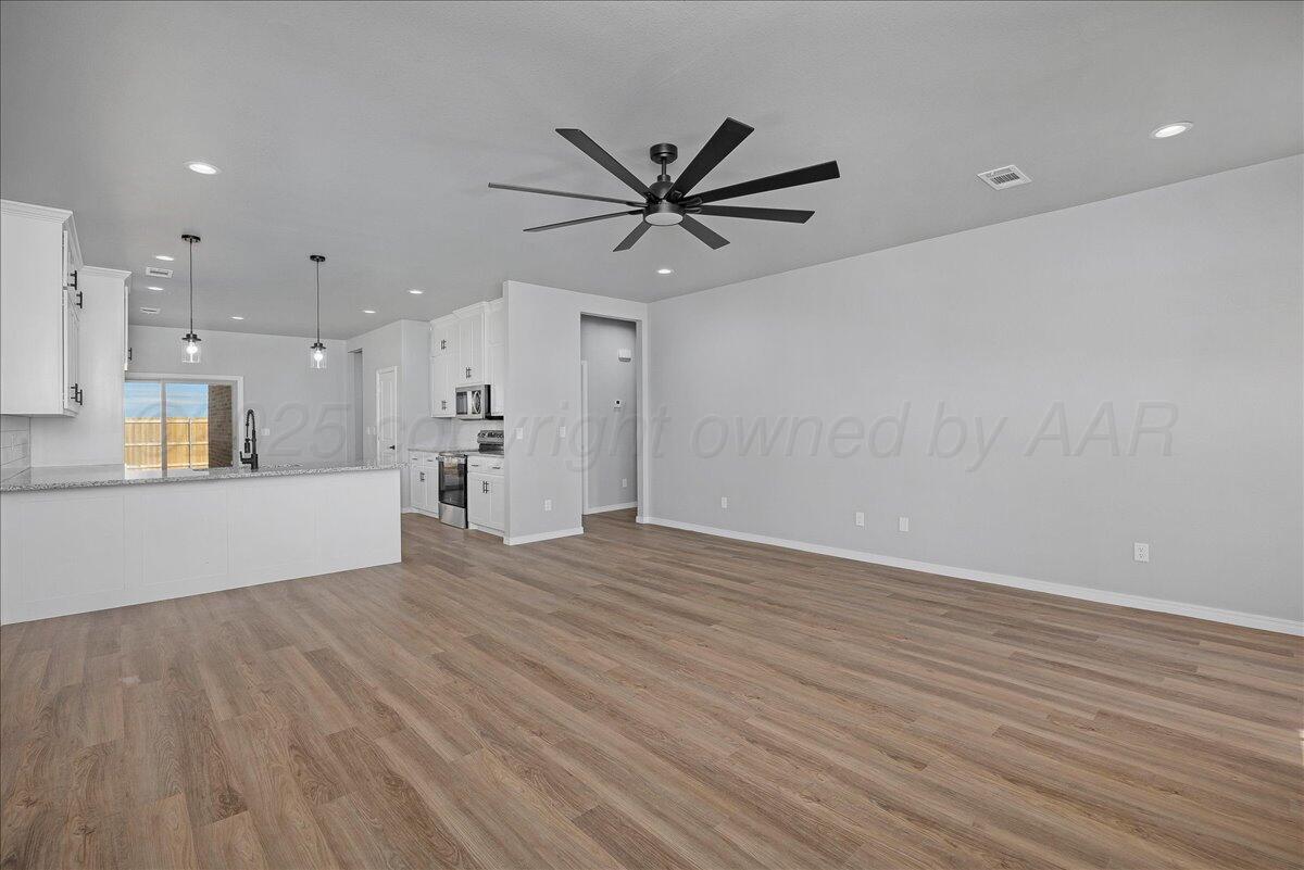 4300 Beacon Road Amarillo, TX 79118 - Photo 6 of 20 a view of a kitchen with a dishwasher and wooden floor
