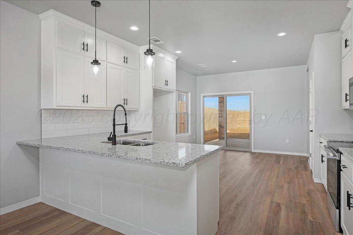 4300 Beacon Road Amarillo, TX 79118 - Photo 7 of 20 a bathroom with a granite countertop sink a toilet a large mirror and vanity