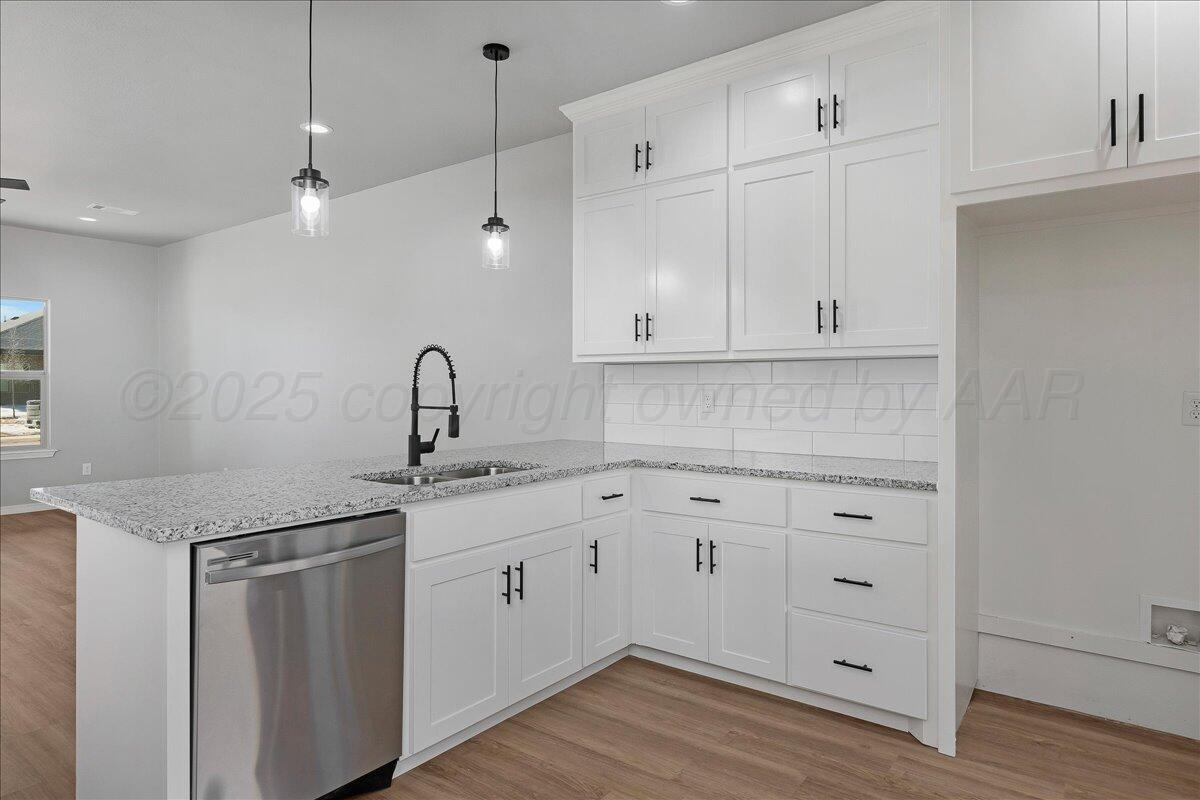 4300 Beacon Road Amarillo, TX 79118 - Photo 9 of 20 a kitchen with white cabinets appliances and sink