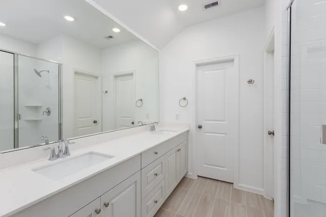 a spacious bathroom with a double vanity sink mirror and double