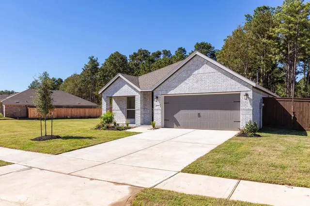 an aerial view of a house with a lake