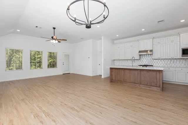 a view of kitchen with granite countertop cabinets and wooden floor